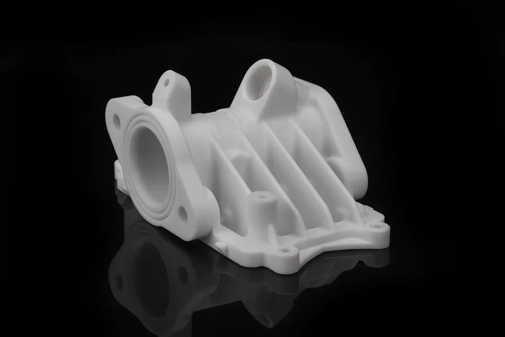 White mechanical component on black background