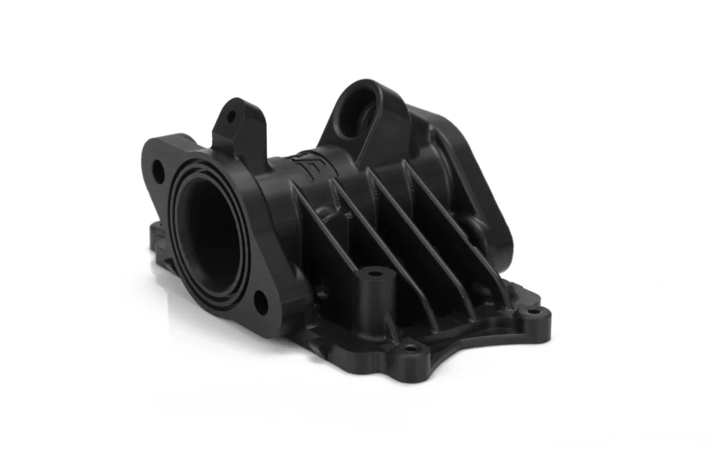 Black automotive engine part on white background