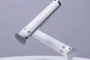 Two white wall-mounted showerheads on a gray background.