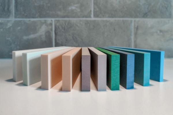 Colorful stacked rectangular tiles on white surface.