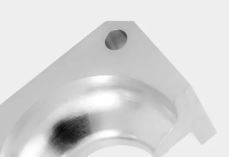 Metal corner bracket with rounded edge and hole.